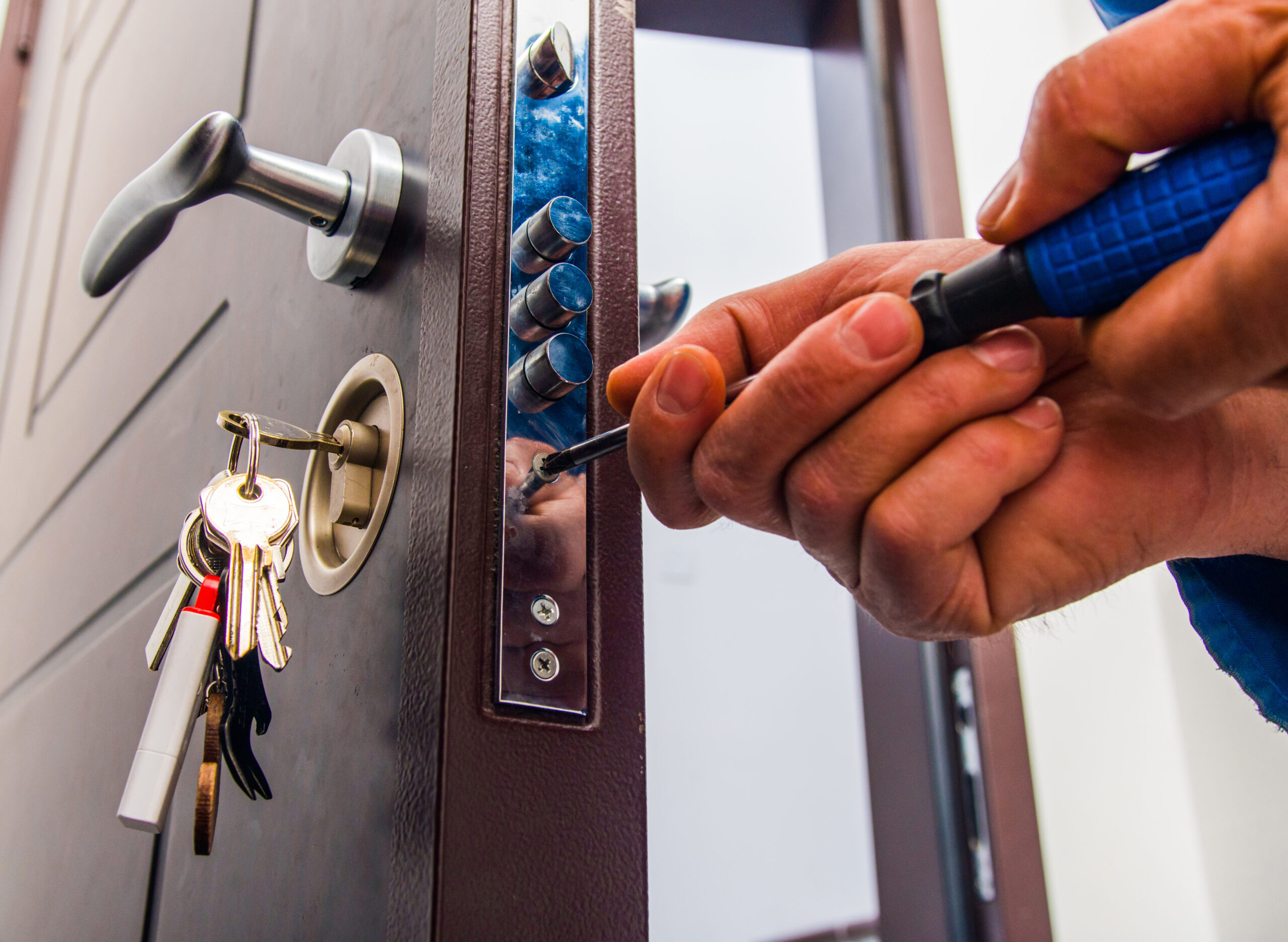 Handyman repairs the door lock Locksmith installs a deadbolt to enhance security - essential marketing can boost service visibility