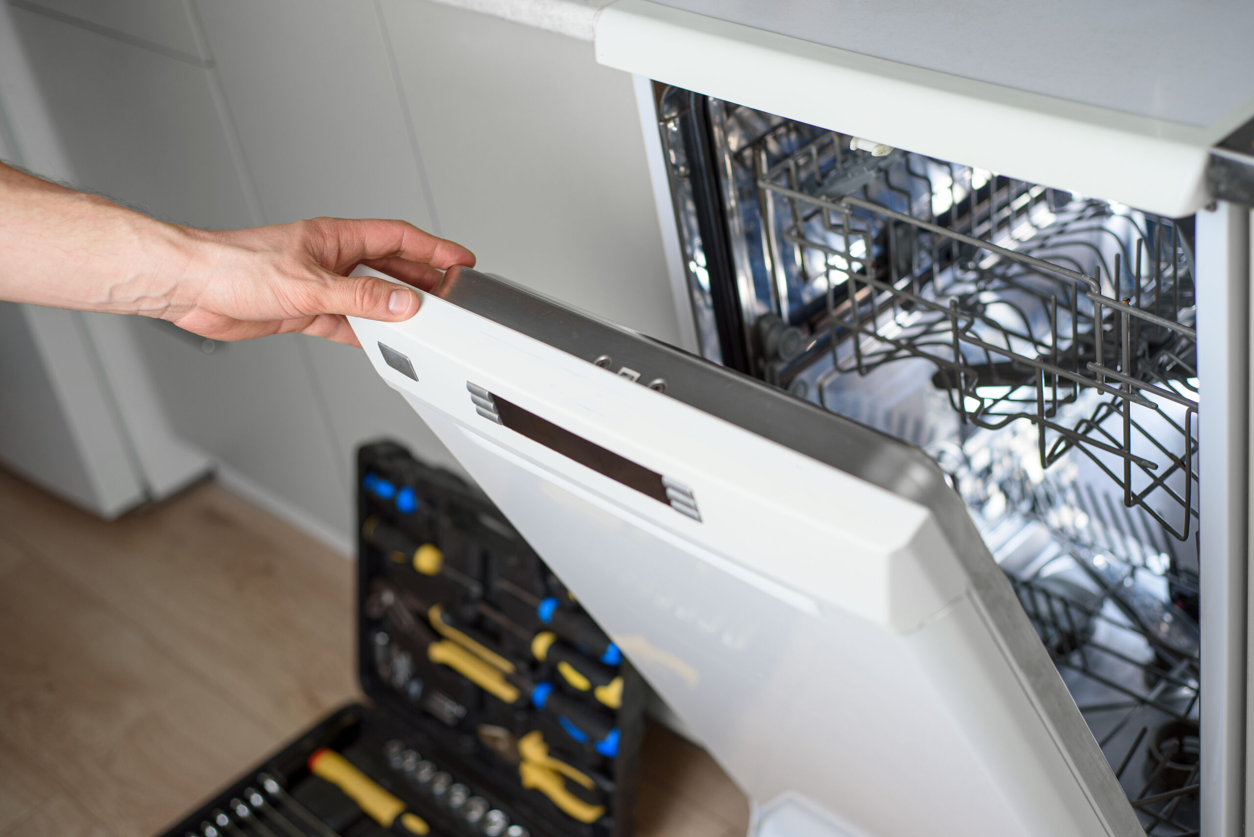 Technician meticulously inspecting a dishwasher, symbolizing expert appliance repair service in action. Technician meticulously inspecting a dishwasher, symbolizing expert appliance repair service in action.